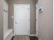 Inviting entryway with coat rack bench, rug, and white door, creating a welcoming first impression at 1227 Highbury Dr, Danville, IN 46122