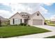 Charming single-Gathering home with a brick exterior, lush green lawn, and driveway leading to a two-car garage at 1227 Highbury Dr, Danville, IN 46122