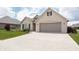 Attractive single-Gathering home boasting a brick facade, two-car garage, and well-kept lawn at 1227 Highbury Dr, Danville, IN 46122