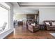 Open-concept living room with hardwood floors, a view into the kitchen, and lots of sunlight at 1227 Highbury Dr, Danville, IN 46122