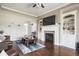 Spacious living room with a fireplace, built-in shelving, and plenty of natural light at 1227 Highbury Dr, Danville, IN 46122