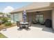 Outdoor patio with seating area including table, chairs and blue umbrella, ideal for relaxing and entertaining at 1227 Highbury Dr, Danville, IN 46122