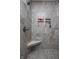 This shower features tile walls, a shower seat, and two built-in shelves at 1227 Highbury Dr, Danville, IN 46122