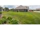 Expansive yard showcases a meticulously maintained lawn, accompanied by an attractive home and lush greenery at 1227 Highbury Dr, Danville, IN 46122