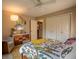 Bedroom features colorful dresser, bed with patterned bedding, sitting area and closet at 131 Olde Mill Bay, Indianapolis, IN 46260