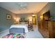 Spacious bedroom boasts a ceiling fan, carpet flooring and a contemporary dresser at 131 Olde Mill Bay, Indianapolis, IN 46260