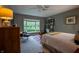 Comfortable bedroom with large window overlooking water feature, bookshelf and soft carpet at 131 Olde Mill Bay, Indianapolis, IN 46260