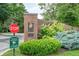 Community entrance with brick signage, lush greenery, and a 'Stop' sign for safety at 131 Olde Mill Bay, Indianapolis, IN 46260