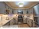 Updated kitchen with stainless steel appliances, granite counters, and white subway tile backsplash at 131 Olde Mill Bay, Indianapolis, IN 46260