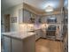 Bright kitchen featuring stainless appliances, stone countertops, and tile flooring at 131 Olde Mill Bay, Indianapolis, IN 46260