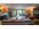 Inviting living room with a fireplace, comfortable seating, and a view of the water at 131 Olde Mill Bay, Indianapolis, IN 46260