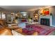 Comfortable living room with fireplace, plush seating and stylish decor and furnishings at 131 Olde Mill Bay, Indianapolis, IN 46260