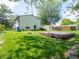Spacious backyard featuring a deck, manicured lawn, and lush greenery, perfect for outdoor activities and entertaining at 1325 Countryside Ln, Indianapolis, IN 46231