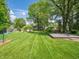 Spacious backyard featuring a well-maintained lawn, mature trees, and a deck, perfect for outdoor living at 1325 Countryside Ln, Indianapolis, IN 46231