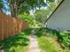 Backyard with lush lawn, stepping stone walkway, wooden fence and tidy garden beds at 1325 Countryside Ln, Indianapolis, IN 46231