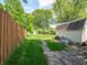 Backyard with lush lawn, stepping stone walkway, wooden fence and utility shed at 1325 Countryside Ln, Indianapolis, IN 46231