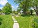 Expansive backyard featuring a lush lawn, mature trees, shed, and deck, creating a private oasis at 1325 Countryside Ln, Indianapolis, IN 46231