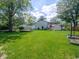 Large, grassy backyard with utility shed and tidy garden beds at 1325 Countryside Ln, Indianapolis, IN 46231
