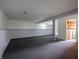 Spacious finished basement with neutral carpet and painted walls and view to laundry area at 1325 Countryside Ln, Indianapolis, IN 46231