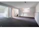 Carpeted basement featuring painted paneling and access to the stairs at 1325 Countryside Ln, Indianapolis, IN 46231