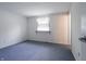 Bedroom featuring a window with carpeted floors and white walls at 1325 Countryside Ln, Indianapolis, IN 46231