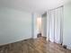 Bright bedroom with wood-look flooring, fresh paint and a doorway to another room at 1325 Countryside Ln, Indianapolis, IN 46231