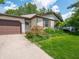Well-maintained home featuring a landscaped front yard with a walkway leading to the front door and two-car garage at 1325 Countryside Ln, Indianapolis, IN 46231