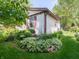 Well-maintained home featuring beautiful garden beds with flowering plants and lush greenery around the house at 1325 Countryside Ln, Indianapolis, IN 46231