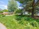 Landscaped front yard with lush green lawn and flowering plants in front of a single Gathering house at 1325 Countryside Ln, Indianapolis, IN 46231