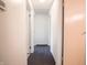 Neutral hallway featuring carpeted flooring and multiple doors at 1325 Countryside Ln, Indianapolis, IN 46231