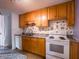 Well-lit kitchen with granite countertops, ample cabinet space, and modern white appliances at 1325 Countryside Ln, Indianapolis, IN 46231