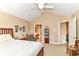 Spacious bedroom with vaulted ceiling flows into an en-suite bathroom with a view of a home office area at 13807 Rue Fontaine Ln, McCordsville, IN 46055