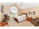Bright bedroom features a vaulted ceiling, arched window, and neutral décor creating a relaxing atmosphere at 13807 Rue Fontaine Ln, McCordsville, IN 46055