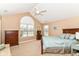 Cozy bedroom features a vaulted ceiling, ceiling fan, and bright windows with a view at 13807 Rue Fontaine Ln, McCordsville, IN 46055