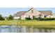 Beautiful stone home with lush landscaping and a tranquil fountain in a picturesque pond at 13807 Rue Fontaine Ln, McCordsville, IN 46055