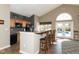 Community kitchen with bar seating and a view of the pool at 13807 Rue Fontaine Ln, McCordsville, IN 46055