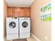 Modern laundry room featuring Samsung washer and dryer with cabinets above at 13807 Rue Fontaine Ln, McCordsville, IN 46055