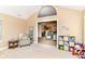 Spacious living area featuring vaulted ceilings and an open layout, seamlessly connecting to the kitchen at 13807 Rue Fontaine Ln, McCordsville, IN 46055