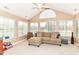 Inviting living room with neutral decor, vaulted ceilings, and large windows offering ample natural light at 13807 Rue Fontaine Ln, McCordsville, IN 46055