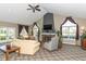 Open concept living room with vaulted ceilings, a fireplace, large windows, and comfortable seating at 13807 Rue Fontaine Ln, McCordsville, IN 46055