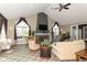 Comfortable community living room with high ceilings, fireplace, TV, and lots of natural light at 13807 Rue Fontaine Ln, McCordsville, IN 46055