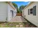 View of a backyard featuring the home, a garage, a fence, and a small cement patio at 1382 S Morgantown Rd, Greenwood, IN 46143