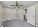A cozy bedroom featuring neutral walls, plush carpet, and a ceiling fan for added comfort at 1382 S Morgantown Rd, Greenwood, IN 46143