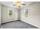 Comfortable bedroom with natural light, neutral walls, plush gray carpet and green outdoor views at 1382 S Morgantown Rd, Greenwood, IN 46143
