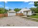 View of the home's exterior, with the detached garage and gravel driveway enhancing curb appeal at 1382 S Morgantown Rd, Greenwood, IN 46143