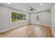 Bright living room featuring hardwood floors, a large window, and a decorative glass front door at 1382 S Morgantown Rd, Greenwood, IN 46143