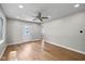 Spacious living room with hardwood floors, ceiling fan, recessed lighting and inviting front door at 1382 S Morgantown Rd, Greenwood, IN 46143