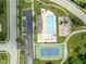 Aerial view of community amenities with a pool, tennis court, playground and plenty of parking at 13861 Barberry Ct, Carmel, IN 46033