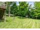 Beautiful backyard featuring a hammock strung between trees, a playset, and a well-manicured lawn at 13861 Barberry Ct, Carmel, IN 46033