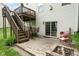 Patio area with brick pavers, stairs to the deck, and outdoor seating, perfect for relaxing at 13861 Barberry Ct, Carmel, IN 46033